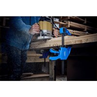 Blue Draper Expert bar clamp with black metal bar, securing wood on workbench, 300mm length.
