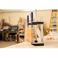 Draper F-Clamp 500mm with blue handles, silver metal bars, and black jaw securing wooden planks on a workbench.