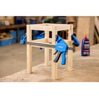 Blue Draper medium duty bar clamp with black handle and 300mm reach, securing wooden frame on workbench.