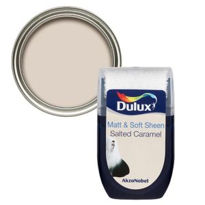 Dulux Salted Caramel Vinyl Matt Emulsion Paint tester pot in a clear container with a silver lid, showcasing a soft beige color ideal for interior walls.