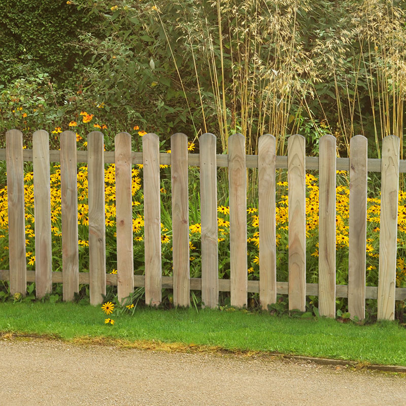 Heavy-duty pressure-treated pale picket fence panel in natural wood color, measuring 6' x 3', with rounded tops, set against a backdrop of vibrant yellow flowers and green grass.
