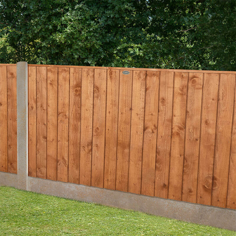 Vertical closeboard fence panel in rich brown timber, measuring 6' x 3' (1.83m x 0.92m), featuring vertical slats and a sturdy concrete base, set against a green garden backdrop.