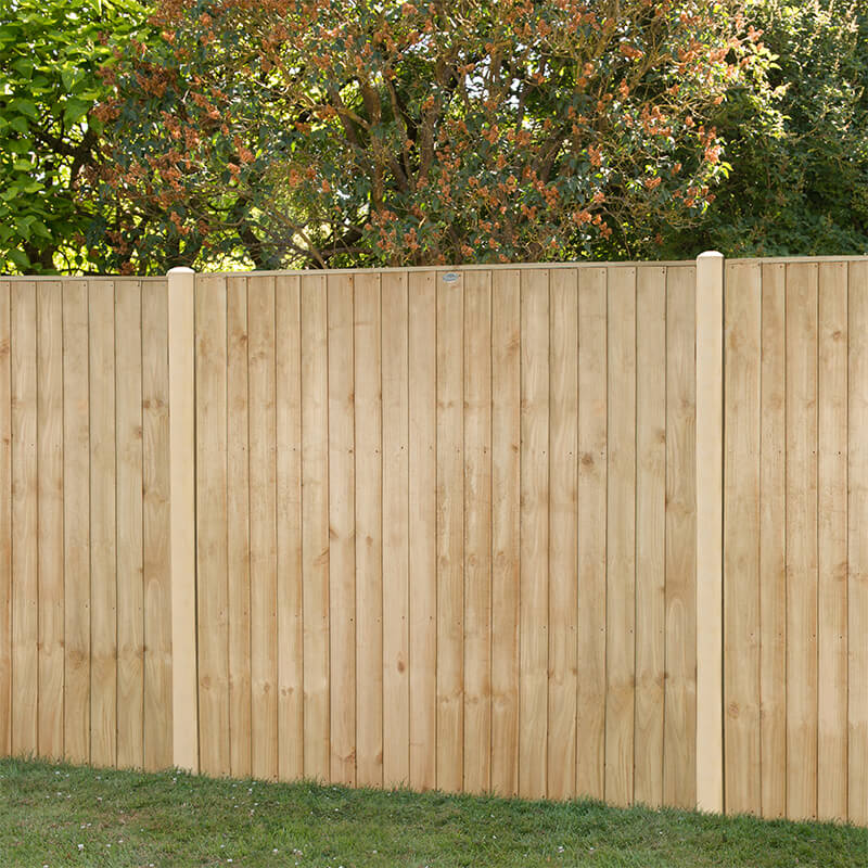 Pressure treated vertical closeboard fence panel in natural wood color, measuring 6' x 5', featuring smooth, straight boards and rounded top posts, set against a green garden backdrop.