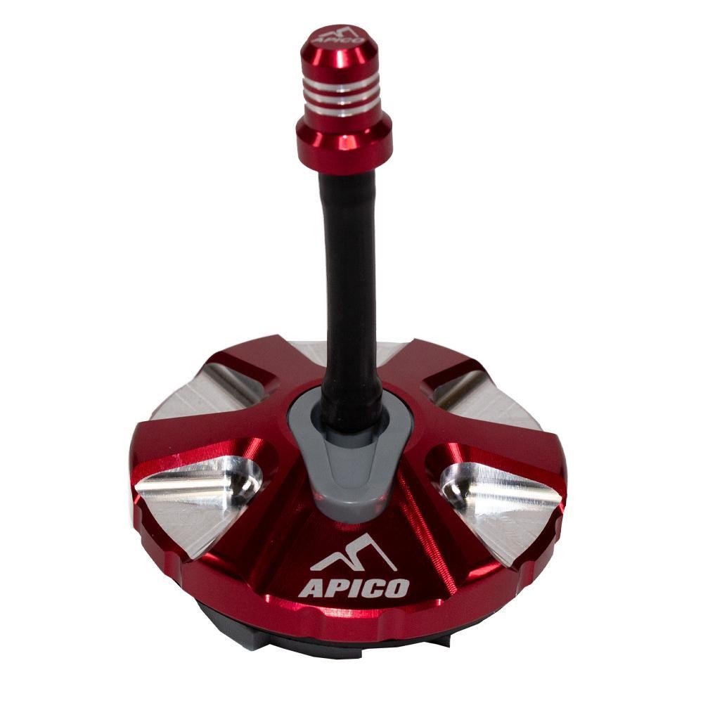 Red alloy fuel cap with a 1/4 turn mechanism, featuring a silver accent and the Apico logo, designed for KTM and Husqvarna models from 2007 to 2023.
