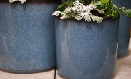 Two glazed blue planters, 36 cm in diameter, featuring a smooth finish and a slightly darker rim, filled with green foliage and decorative plants.