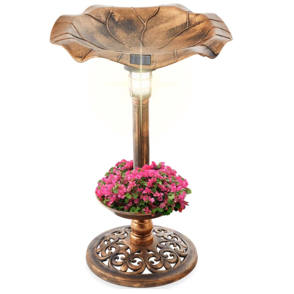 Bronze effect plastic pedestal bird bath feeder features a leaf-shaped basin, solar lamp light, and a decorative base with floral accents in vibrant pink.