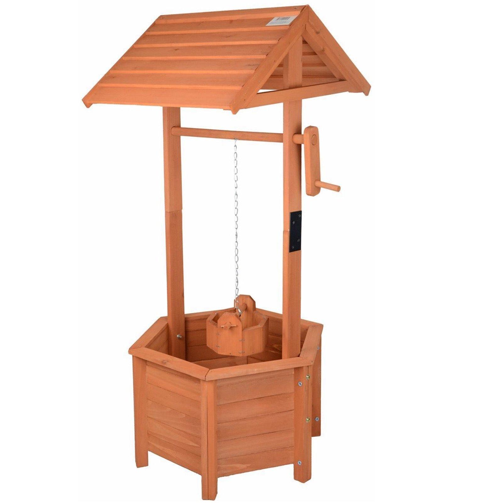 Brown wooden wishing well planter with a slanted roof, a chain, and a bucket, featuring a hexagonal base and slatted design for planting flowers or herbs.