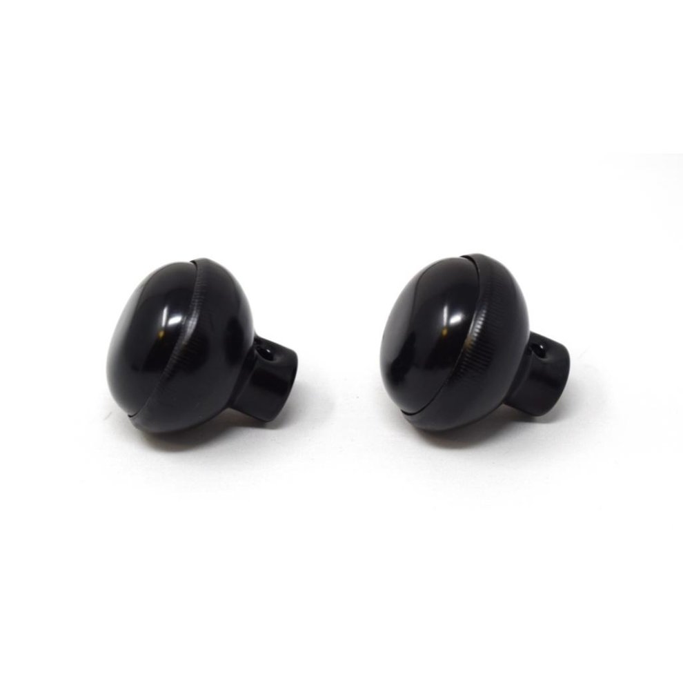 Two glossy black Yale Essentials rim knobs with a rounded design, featuring a smooth finish and a central screw hole for easy installation.