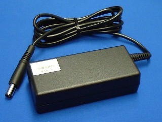 Black HP 412786-001 power adapter with a 65W output, featuring a rectangular body, a textured surface, and a single black cable ending in a cylindrical connector.