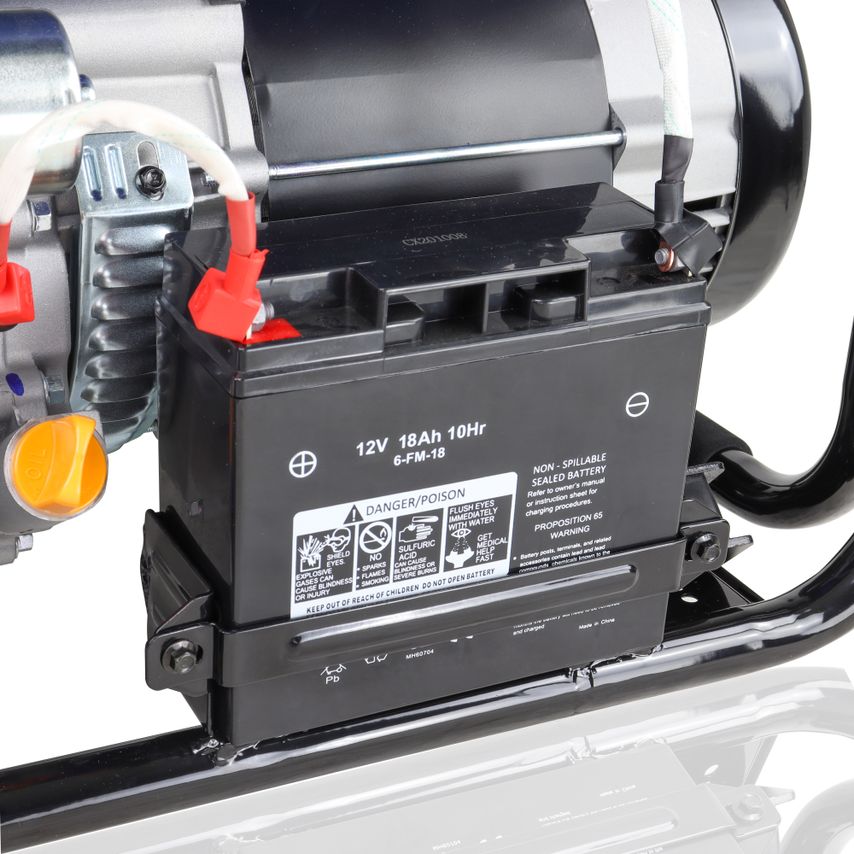 Black battery with red and black connectors, labeled with safety warnings, attached to a metallic generator frame, showcasing a compact design for outdoor power needs.