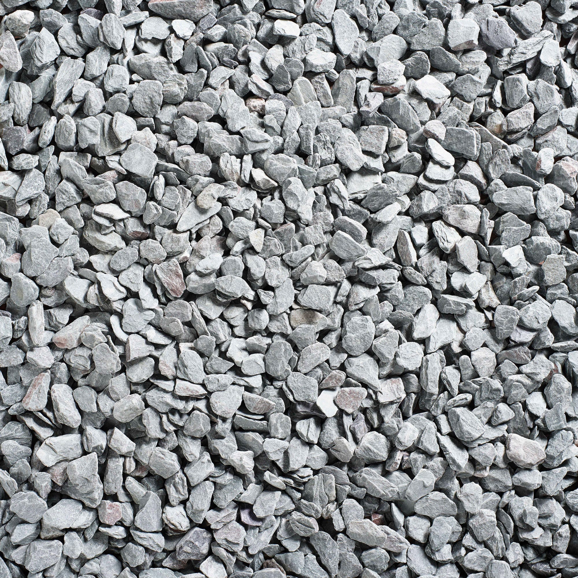 Green slate decorative aggregate in a bulk bag, featuring small, irregularly shaped stones in varying shades of gray, ideal for landscaping and decorative purposes.