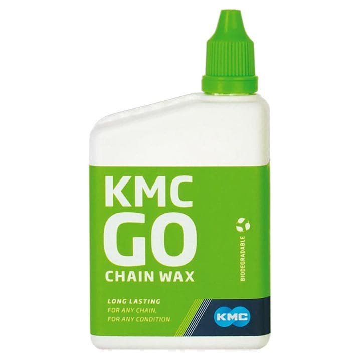 Transparent bottle with a green label, featuring "KMC GO Chain Wax" in bold white letters, a green cap, and a message highlighting its long-lasting, biodegradable formula.