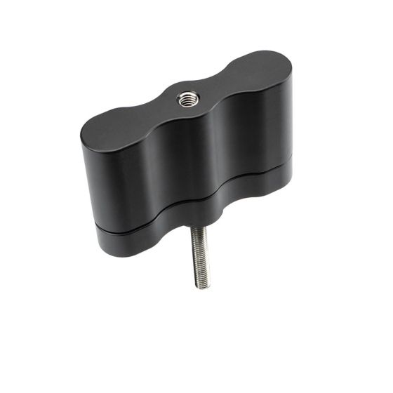 Black aluminum fuel mount extension with a wavy design and a central threaded hole for attachment, featuring a sturdy construction suitable for overland use.