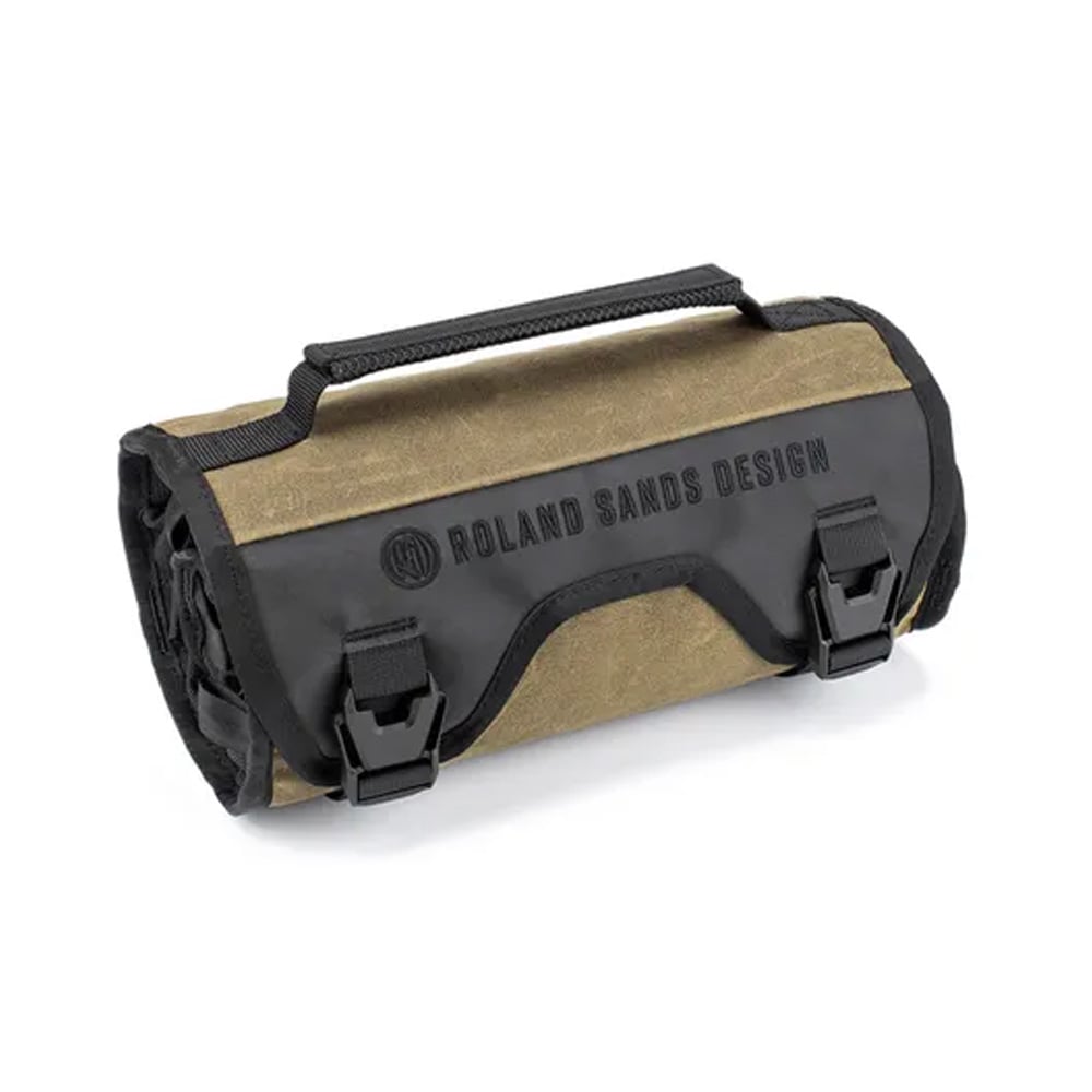Kriega Roland Sands Design Roam tool bag features a durable olive green and black exterior, with a roll-top closure, adjustable straps, and a prominent logo on the front.