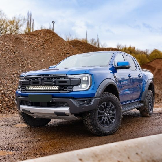 Lazer Lamps Grille Integration Kit with Gen 2 Triple-R 16 Elite Lamp installed on a blue Ford truck, featuring a rugged design, black grille, and powerful LED light bar.