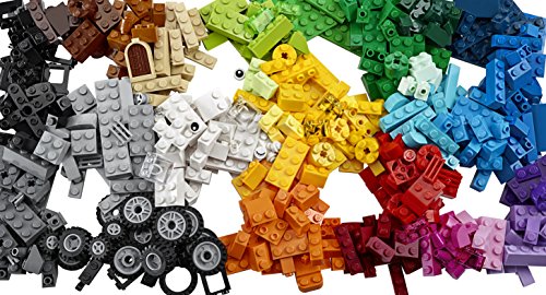 Colorful assortment of LEGO bricks in various shapes and sizes, including wheels, doors, and a mix of vibrant colors like red, blue, yellow, green, and brown.