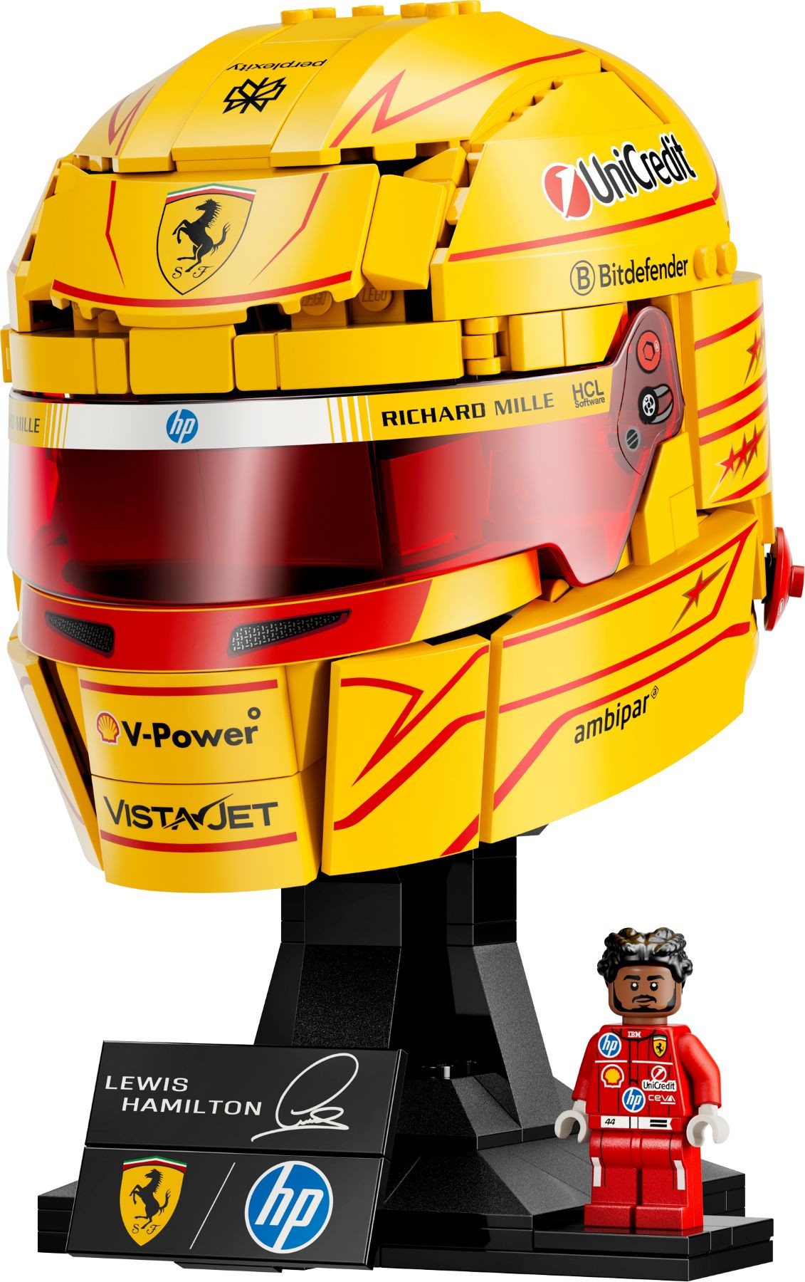 LEGO Scuderia Ferrari helmet construction set in bright yellow with red accents, featuring a transparent visor, mounted on a black stand, accompanied by a mini figure of Lewis Hamilton.