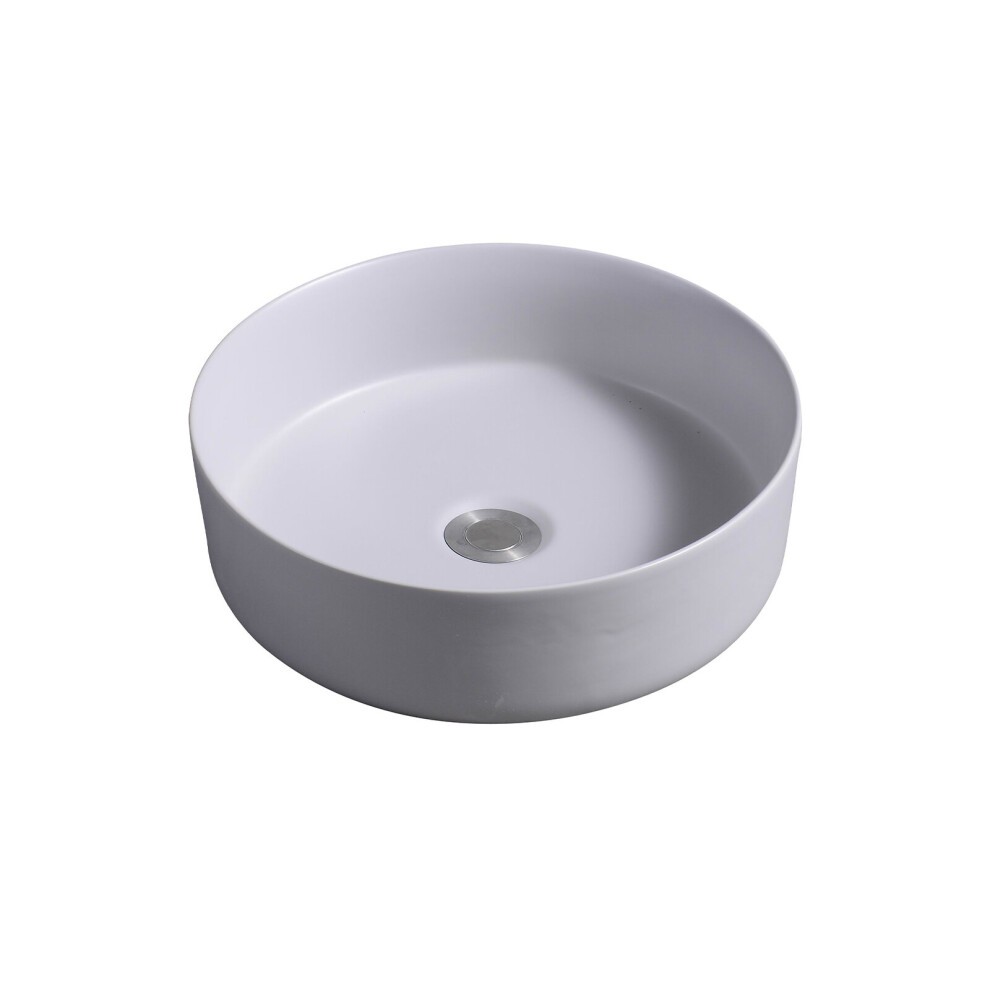 Round ceramic countertop basin in a smooth cement finish, featuring a central drain hole and minimalist design, ideal for modern bathrooms.