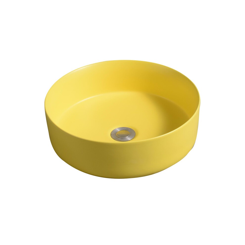 Ceramic round countertop basin in vibrant yellow with a smooth finish and a central drain hole, designed for modern bathrooms.