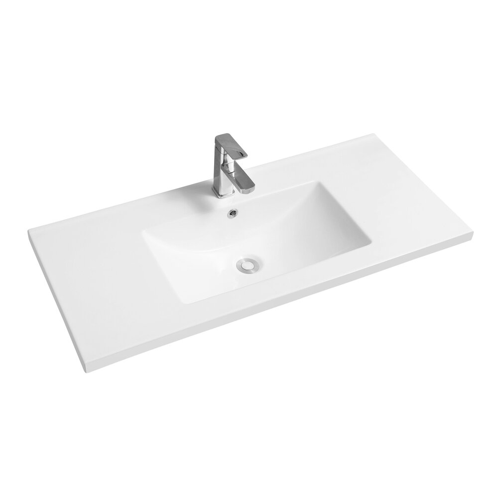 White ceramic inset basin with a scooped mid-edge design, featuring a single rectangular sink and a polished chrome faucet on a sleek rectangular countertop.