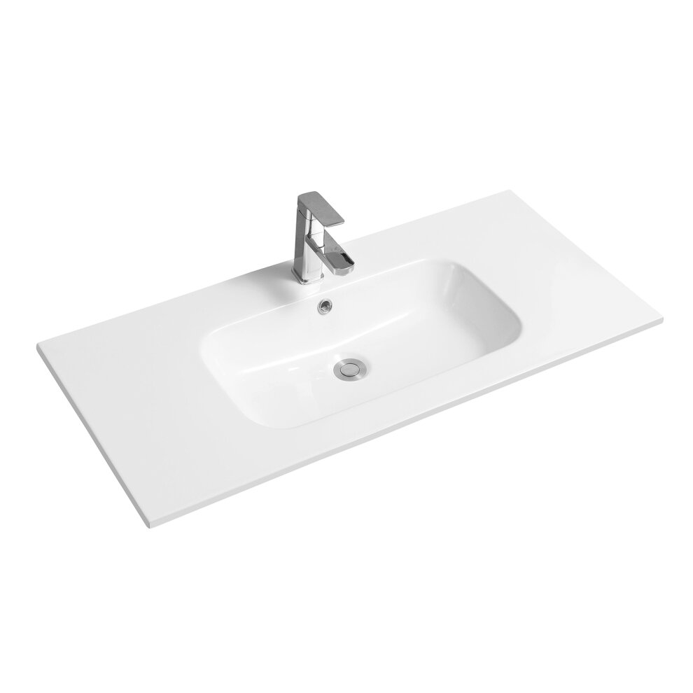 White ceramic inset basin with an oval shape and thin edge, featuring a single faucet hole and a modern chrome faucet, set on a rectangular countertop.