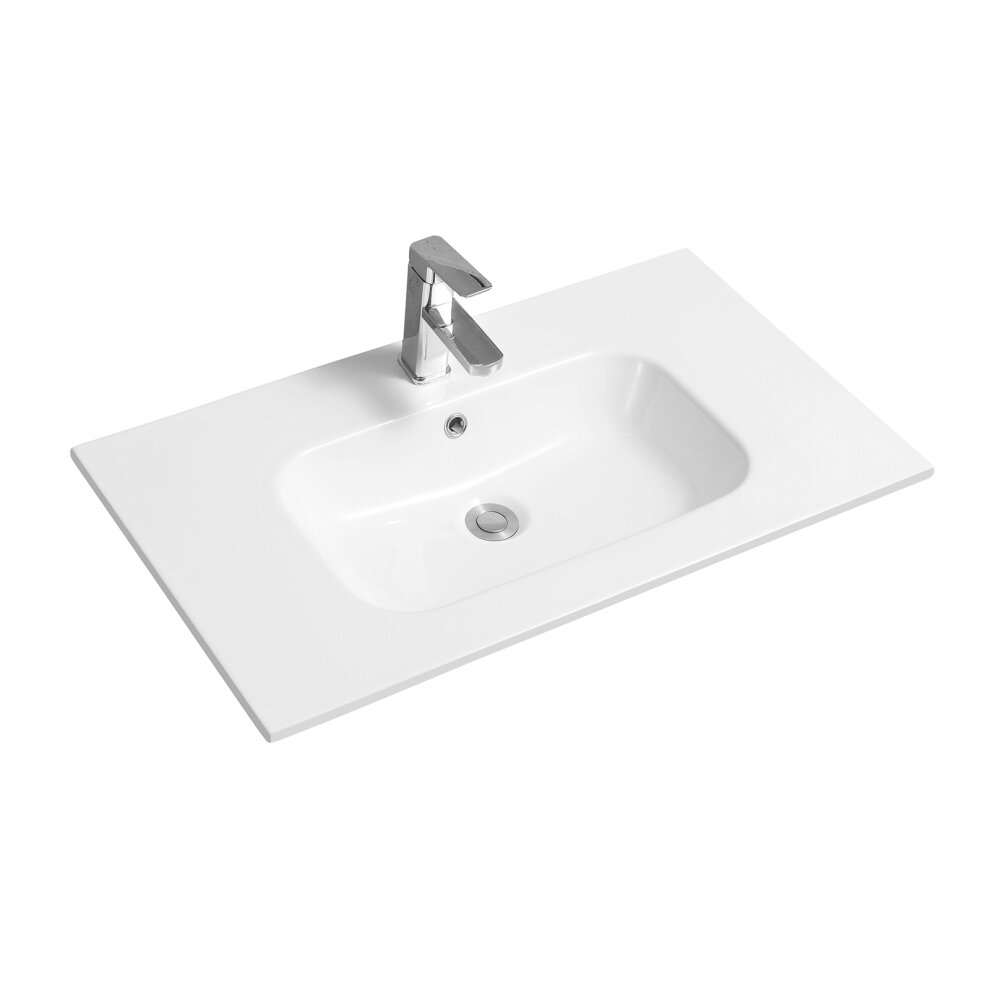 White ceramic inset basin with a thin edge, featuring a rectangular shape, smooth surface, and a central drain hole, complemented by a modern chrome faucet.