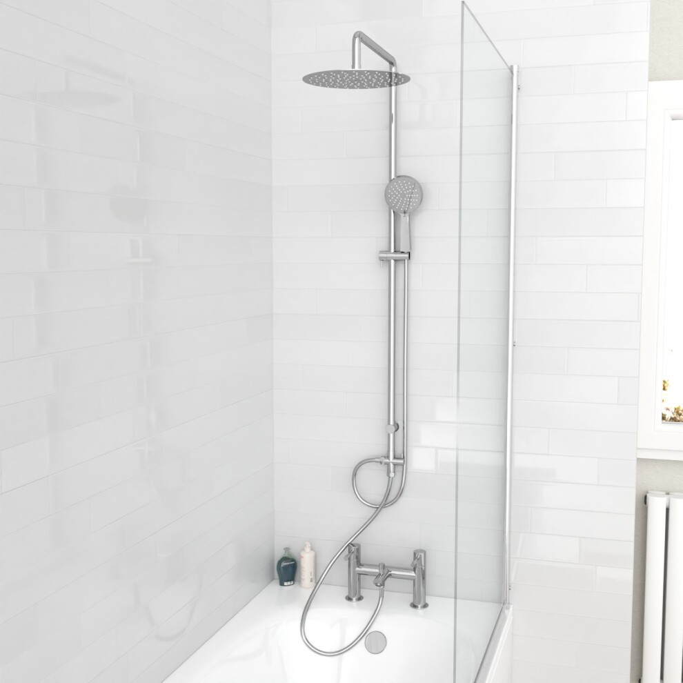 Round shower mixer bath filler tap in chrome finish, featuring a handheld showerhead, riser rail, and sleek design, mounted in a modern bathroom with white tiles.