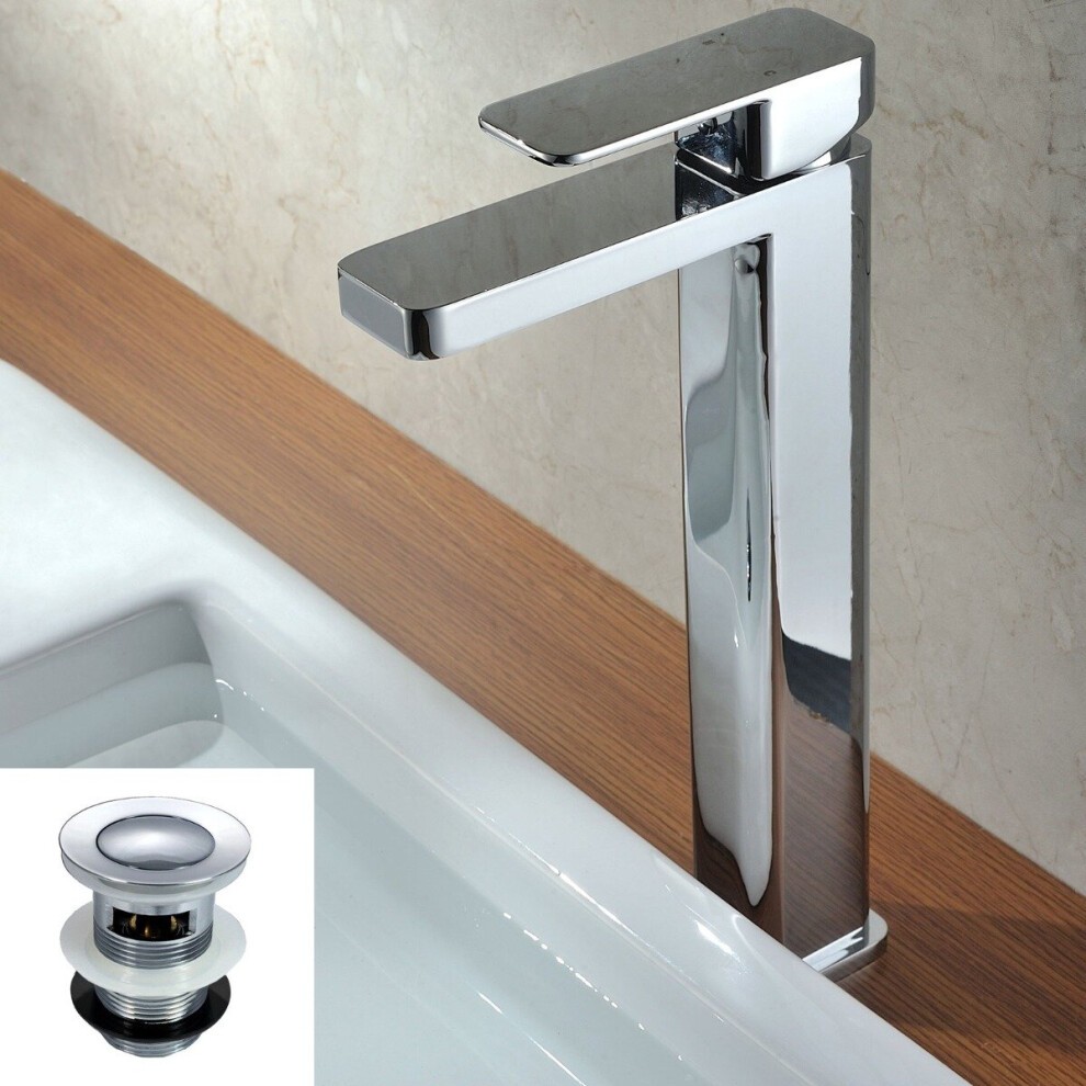 Tall silver monobloc basin mixer tap with a sleek, modern design, featuring a single lever handle and integrated waste, set against a light wooden countertop and white sink.