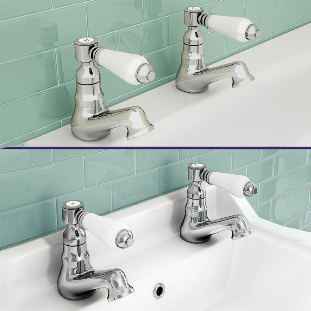 Chrome twin basin and bath taps with white ceramic lever handles, featuring a sleek design against a mint green tiled background.