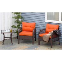 Brown rattan bistro set with two orange-cushioned chairs and a glass-top side table on a patio.