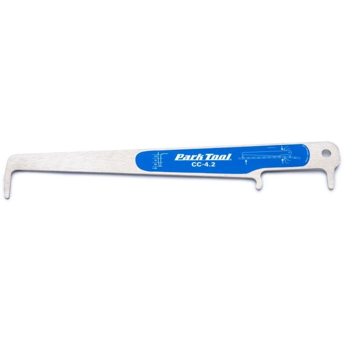 Metal chain checker tool with a blue Park Tool logo, featuring a curved end for measuring chain wear and a scale for precise readings.