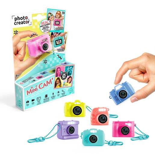 Colorful mini digital cameras in pink, blue, and yellow, featuring a small lens and a strap, displayed alongside a hand holding one, with a box showcasing styles and features.