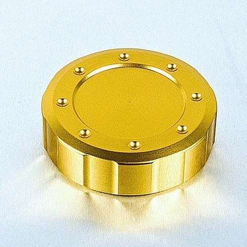 Round, gold alloy reservoir cap with a 61mm outer diameter, featuring a smooth surface and decorative raised dots around the edge for grip.