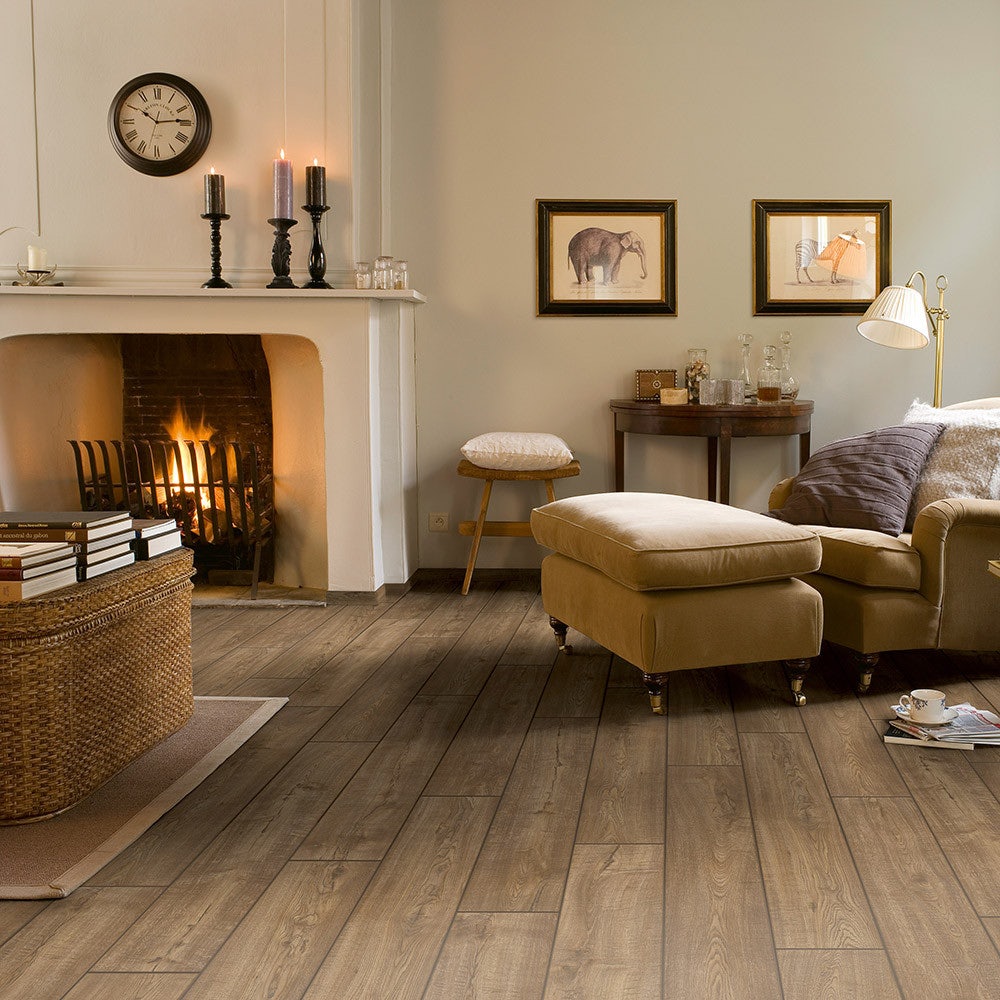 Quick-Step Impressive Scraped Oak Grey Brown laminate flooring features a textured wood appearance with warm grey and brown tones, ideal for enhancing interior spaces.