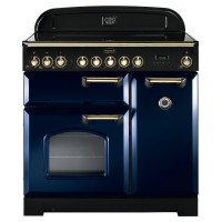 Classic 90cm ceramic range cooker in regal blue with brass trim, featuring six control knobs, a large oven window, and a stylish curved back panel.