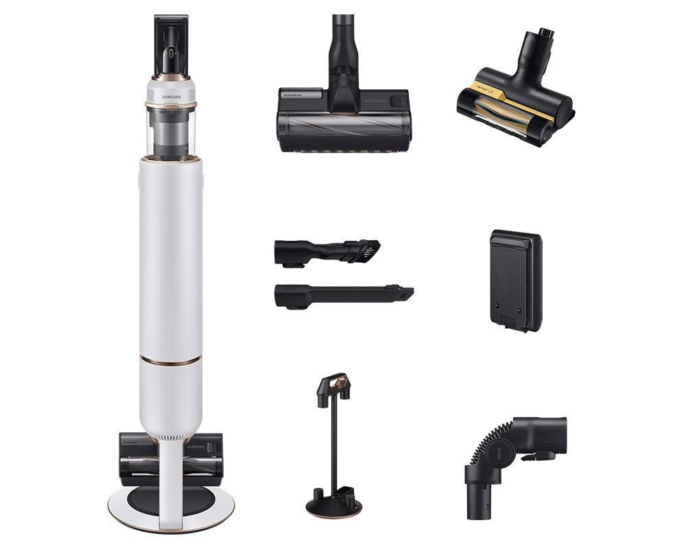 Samsung VS20B95823W cordless stick vacuum cleaner in white with gold accents, featuring multiple attachments, a sleek design, and a base for easy storage.