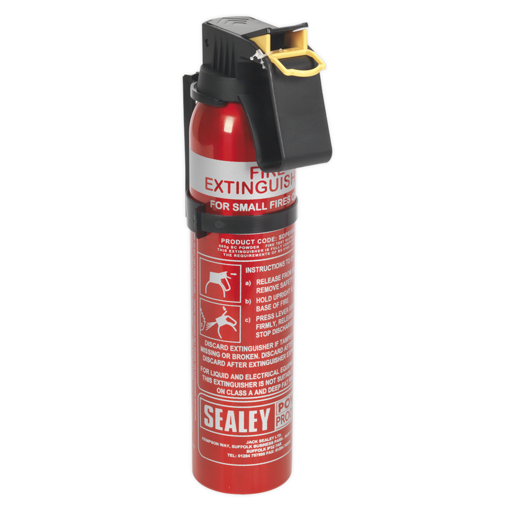 Red 0.6kg dry powder fire extinguisher with a black plastic handle, safety pin, and clear instructions printed on the body, designed for small fires.