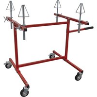 Red Sealey alloy wheel stand with adjustable arms, four caster wheels, and triangular supports for painting and repair.