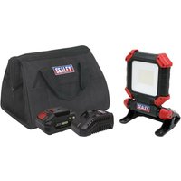 Sealey cordless LED worklight kit with black and red light, battery, charger, and black carrying bag.