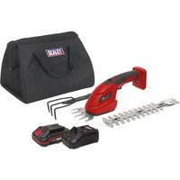 Red and black Sealey cordless garden tool kit with hedge trimmer, grass shear, battery, charger, and black carry bag.