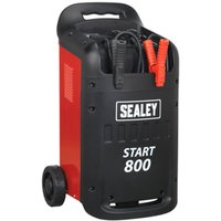 Red and black Sealey START800 heavy duty starter/charger with wheels, handle, and attached cables with clamps.