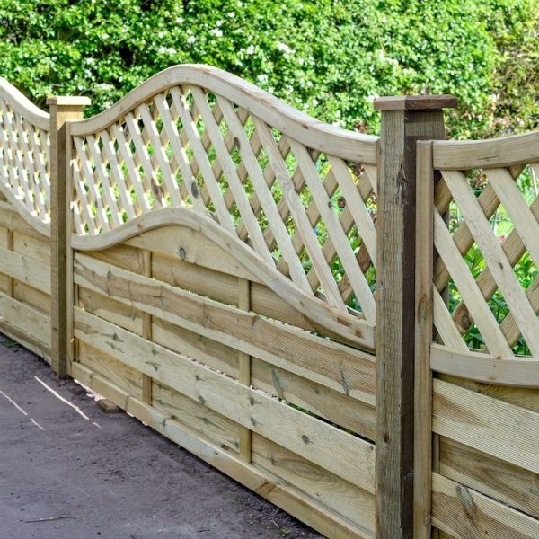 A 0.9m high wooden fence panel featuring a wavy top design with lattice work, made from treated timber, showcasing a natural wood finish against a green background.