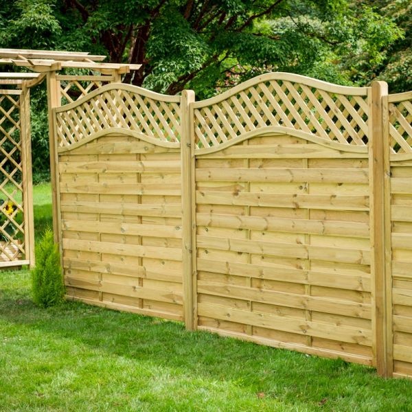 Wooden fence panel in natural finish, 1.8m tall, featuring a decorative curved top and lattice design, set in a green garden with grass and a wooden trellis structure nearby.