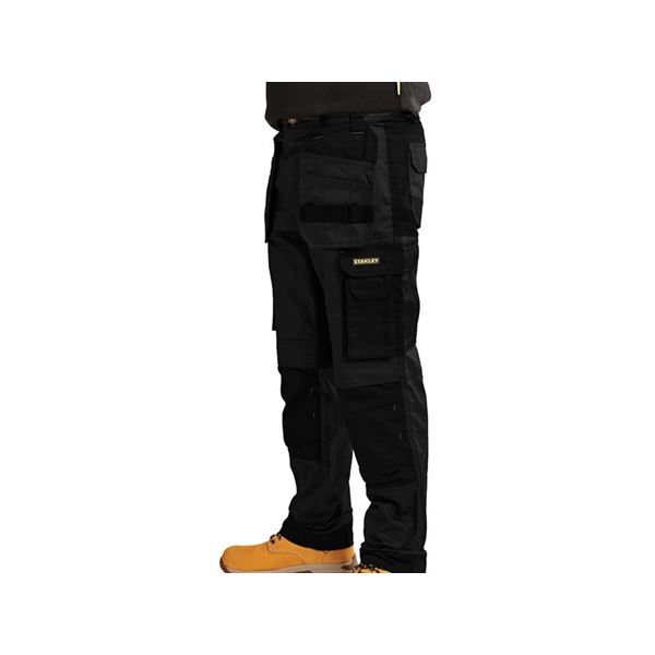 Black slim fit holster trousers with multiple pockets, made from durable material, featuring a Stanley logo patch, designed for waist size 34" and leg length 29".