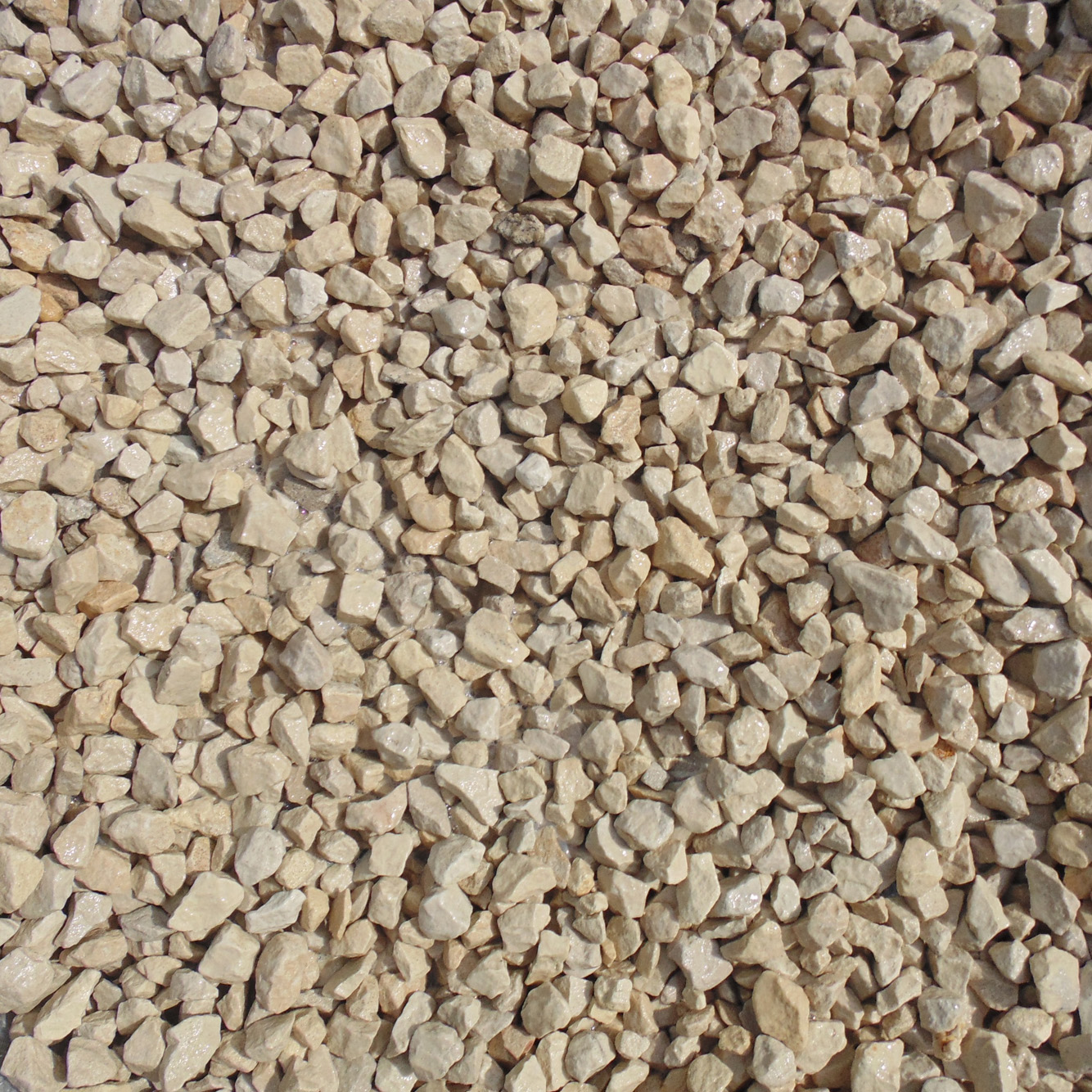 Light beige 20mm chippings made of natural stone, featuring a mix of rounded and angular shapes, ideal for decorative landscaping and pathways.