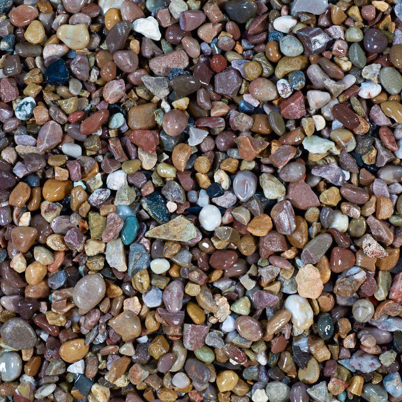 Colorful 20mm pea gravel featuring a mix of browns, reds, and tans, with smooth, rounded stones ideal for landscaping and decorative applications.