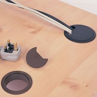 Light grey Trend cable tidy insert with round design, open slot for cables, and removable cover on wooden surface.