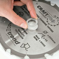 Circular saw blade with silver bush washer, carbide tipped, labeled "Trend Craft Pro" and "200mm, 30mm bore."