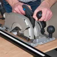Circular saw with silver blade cover, black handle, and 162mm x 48T x 20mm blade cutting wood.