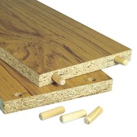 Wooden dowels 10x35mm, beige, shown inserted into particle board edges, with additional dowels lying nearby.